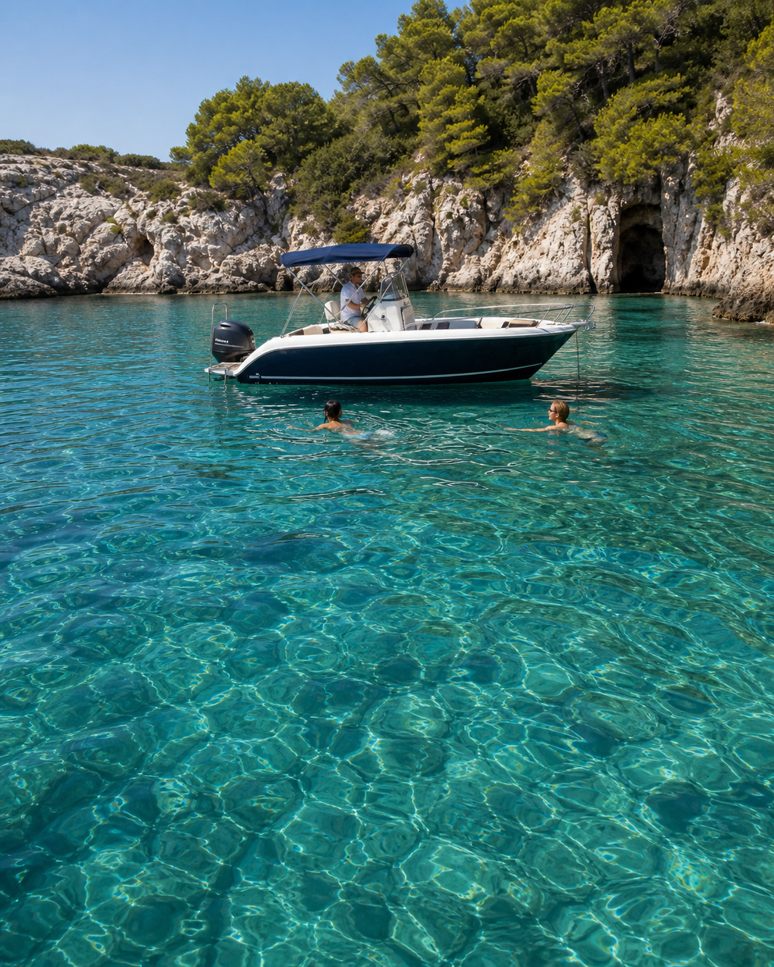 Private boat with guests swimming in a secluded Adriatic cove